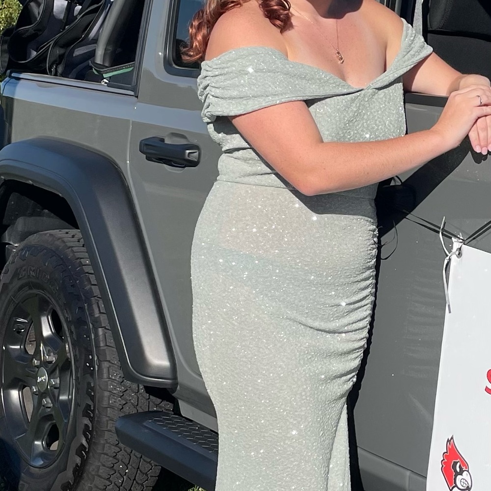 Long glitter off shoulder dress with slit in front.